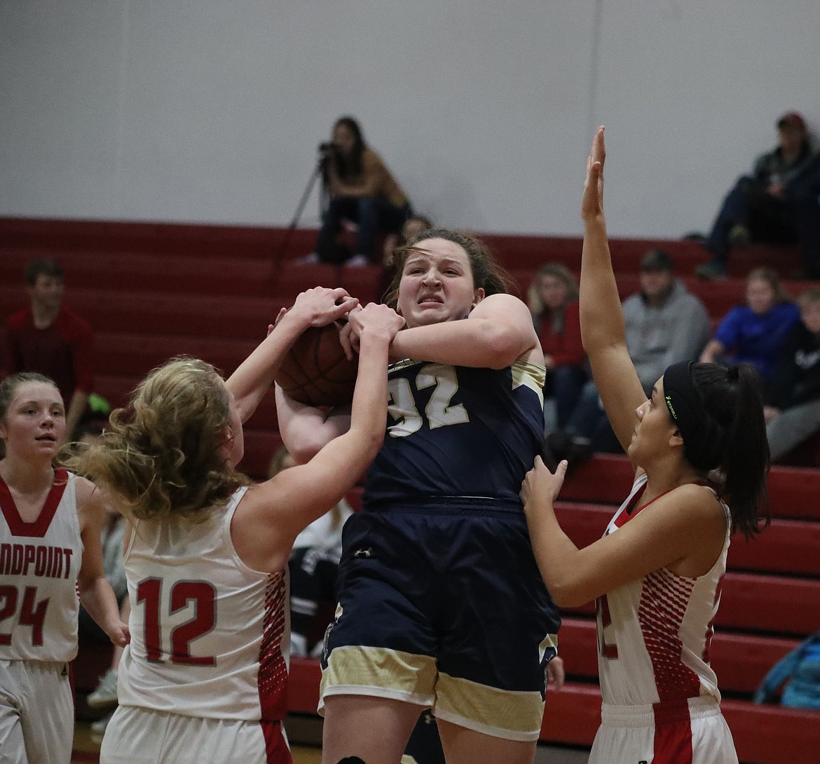 (Photo by KYLE CAJERO)
Brooklen Steiger (12) and Bella Phillips (22) surround Timberlake&#146;s Blayre Jeffs during the fourth quarter of Sandpoint&#146;s 56-16 loss.