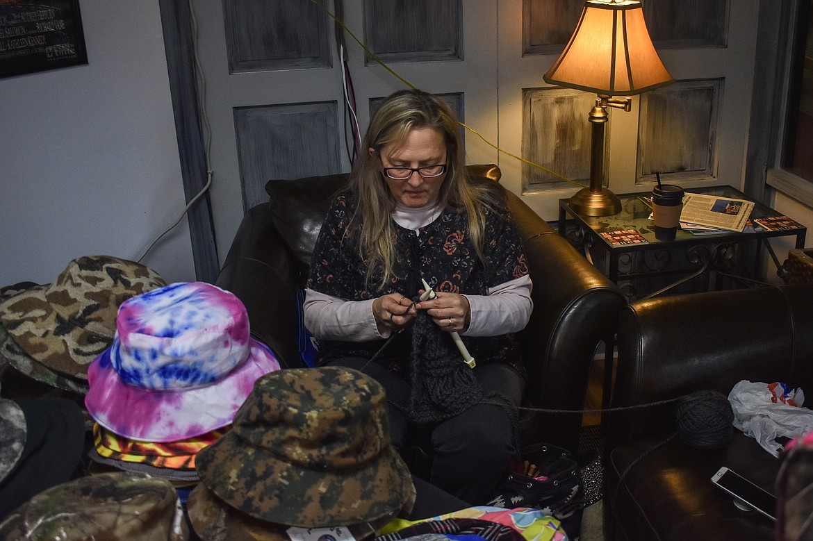 Shaunie Fisher, of Alpaca Montana Mill, takes a minute to work on her knitting while helping out Eric Nyberg with his Krinklehorn Caps booth at AuntT&#146;s Coffee Corner on Black Friday. (Ben Kibbey/The Western News)