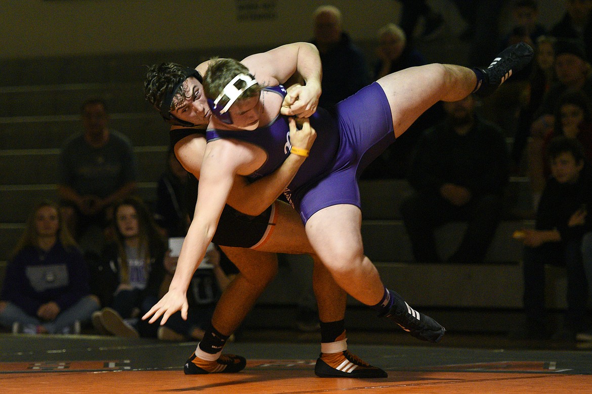 Flathead's Sebastian Koch throws Butte's Kyle Harding at heavyweight at Flathead High School on Friday. Koch won by pin. (Casey Kreider/Daily Inter Lake)