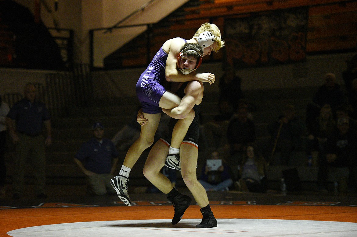 Flathead's Fin Nadeau throws Butte's Scout Allen at 132 pounds at Flathead High School on Friday. Nadeau won by decision. (Casey Kreider/Daily Inter Lake)