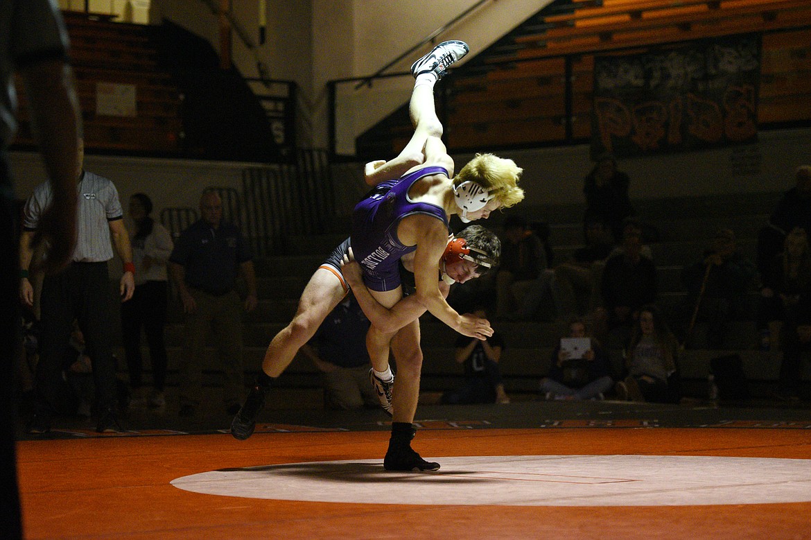 Flathead's Fin Nadeau throws Butte's Scout Allen at 132 pounds at Flathead High School on Friday. Nadeau won by decision. (Casey Kreider/Daily Inter Lake)