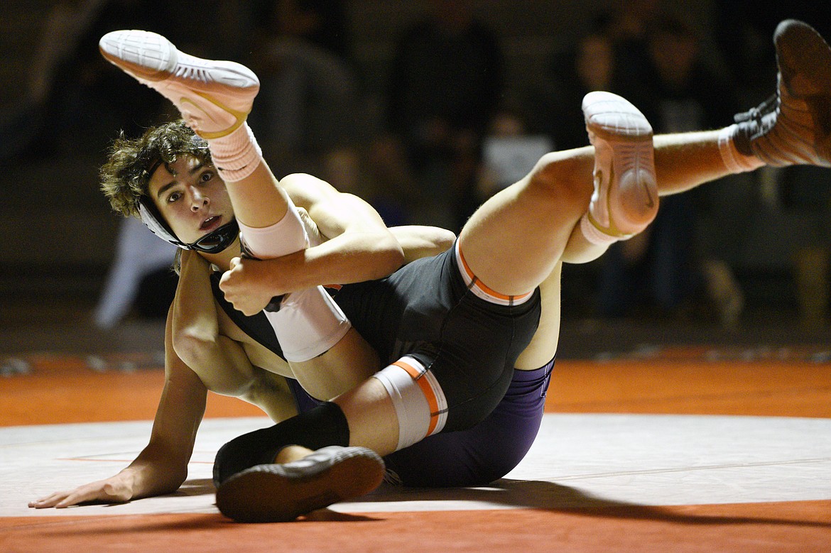 Flathead's Asher Kemppainen wrestles Butte's Wil Queer at 126 pounds at Flathead High School on Friday. (Casey Kreider/Daily Inter Lake)