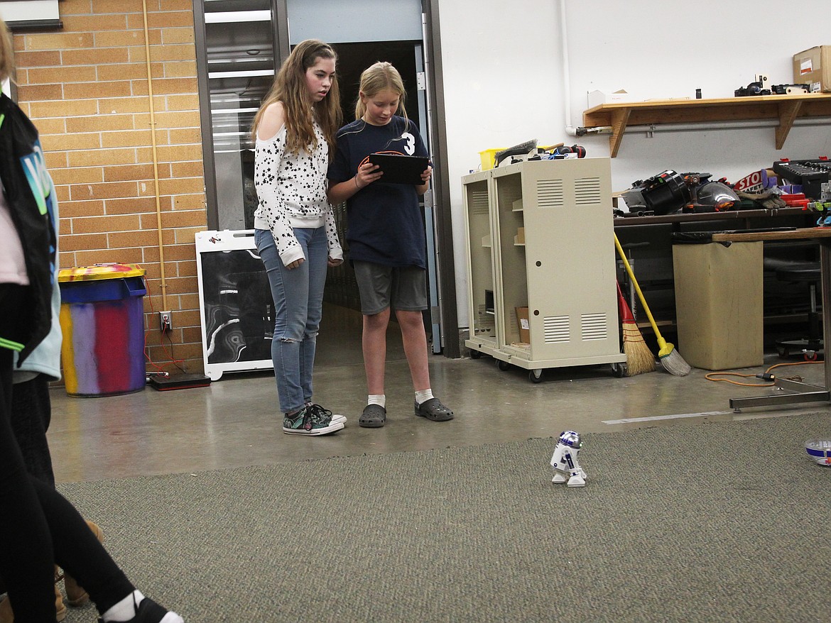 DEVIN WEEKS/Press
Ainsley Lanigan, 14, watches a mini R2-D2 glide across the floor as her brother Maverick, 10, maps its pathway on the Gizmo-CDA floor Saturday during an immersive tech day at North Idaho College. More than 50 people came to the free event, which invited the public to check out new tech devices such as virtual reality headsets and augmented reality applications.