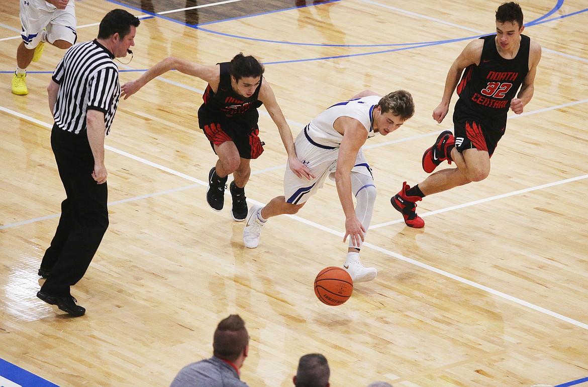 Coeur d&#146;Alene&#146;s Carter Friesz dribbles the ball in traffic between two North Central defenders in Friday night&#146;s game at Viking Court. (LOREN BENOIT/Press)