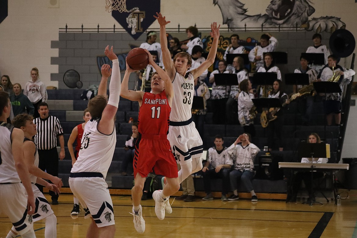 (Photo by KYLE CAJERO)
Sandpoint guard Darren Bailey attempts a putback against Timberlake on Dec. 6.