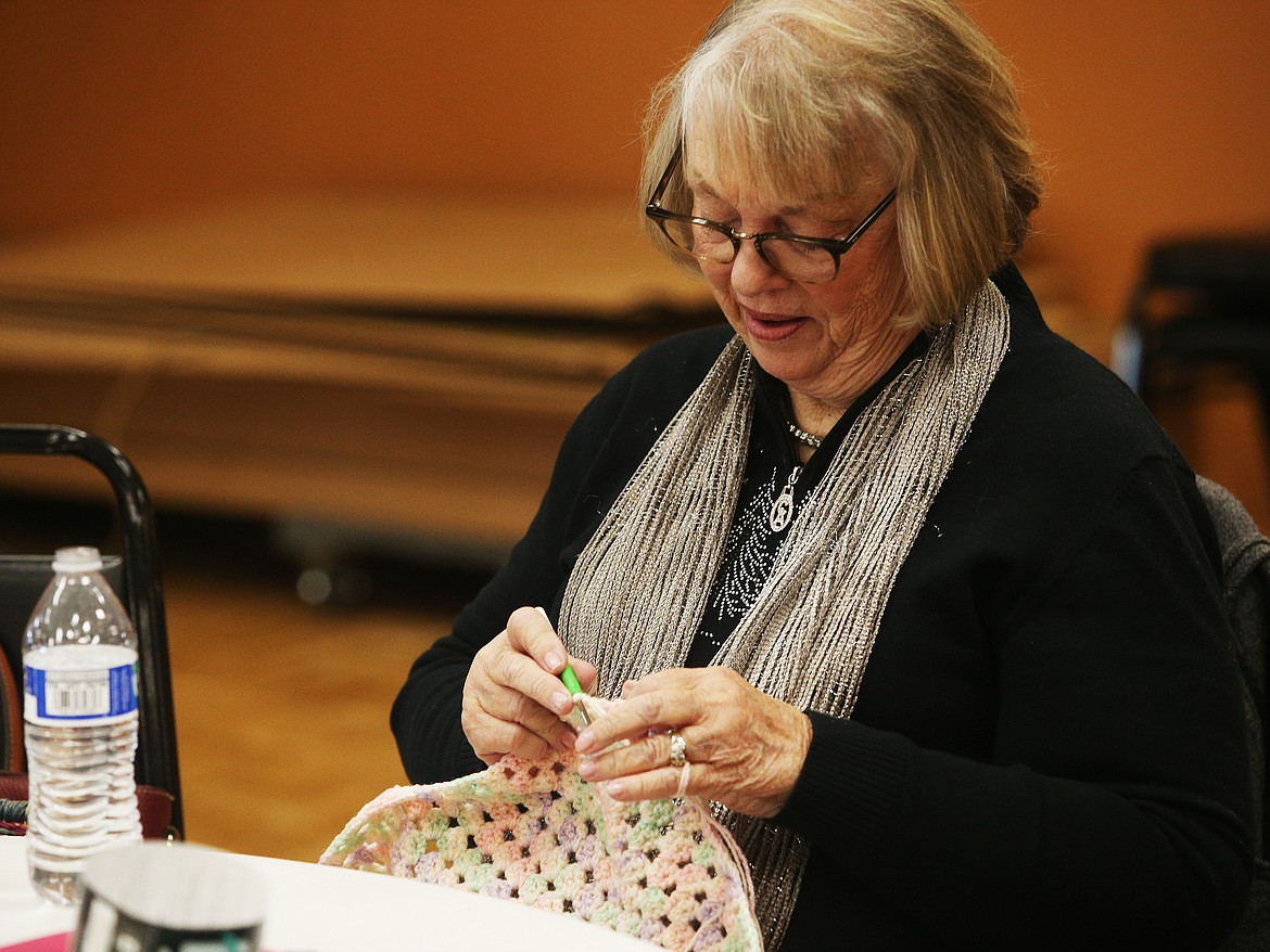 LOREN BENOIT/Press
Su Funkhouser knits a baby blanket Wednesday afternoon at Lake City Center. Ladies in the Knit Wits weaved Mittens, scarves, shrugs, and more for those in need this winter season. Charities like Meals on Wheels, ICARE, area food banks and Early Head Start will distribute the items where needed.