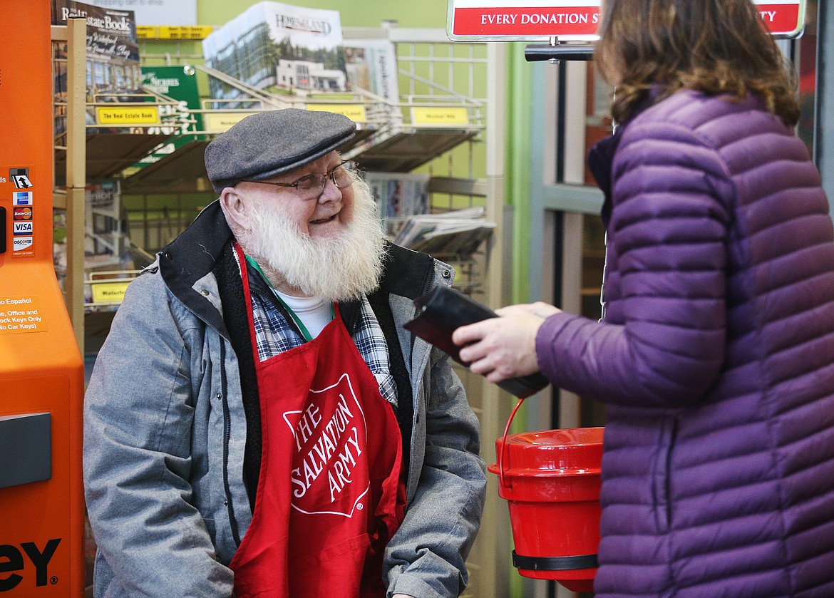 Bell ringer Bill Conner thanks a customer for donating to the Salvation Army on Wednesday at the entrance to Fred Meyer. (LOREN BENOIT/Press)