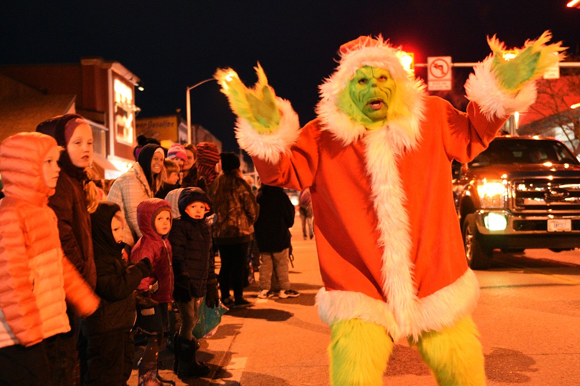 The Grinch jokes with the crowd during the 2018 Kalispell Christmas Parade on Saturday. (Casey Kreider/Daily Inter Lake)