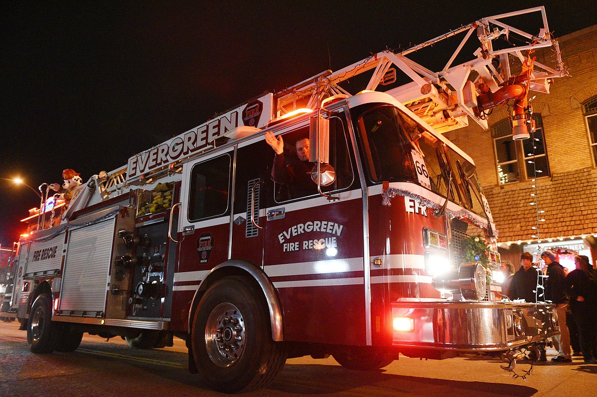 A fire engine from Evergreen Fire Rescue proceeds down Main Street during the 2018 Kalispell Christmas Parade on Saturday. (Casey Kreider/Daily Inter Lake)