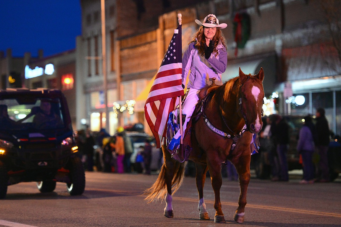 A horse and rider make their way down Main Street during the 2018 Kalispell Christmas Parade on Saturday. (Casey Kreider/Daily Inter Lake)