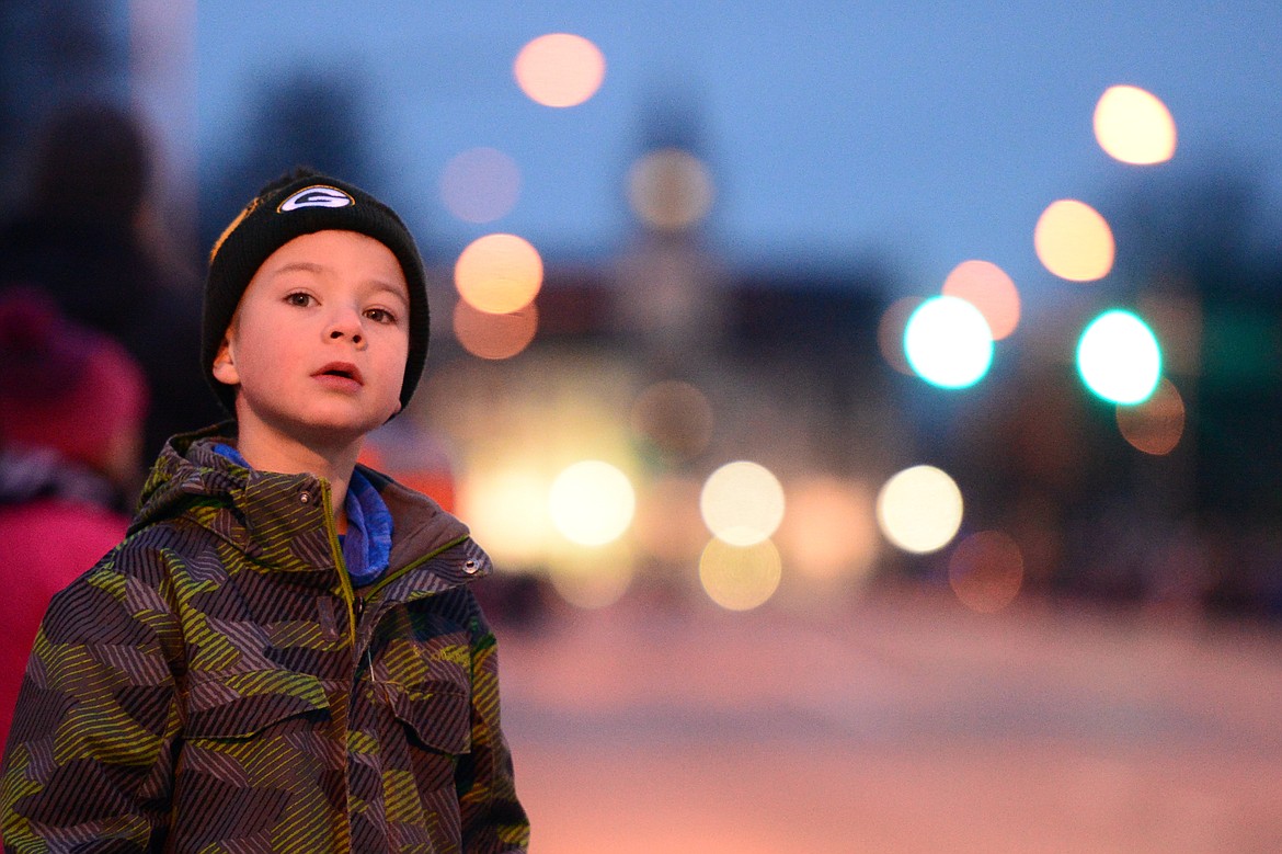 Children wait along Main Street for the start of the 2018 Kalispell Christmas Parade on Saturday. (Casey Kreider/Daily Inter Lake)