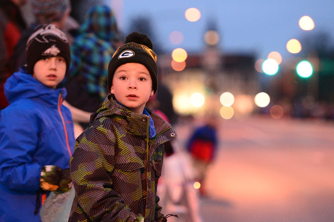 Children wait along Main Street for the start of the 2018 Kalispell Christmas Parade on Saturday. (Casey Kreider/Daily Inter Lake)