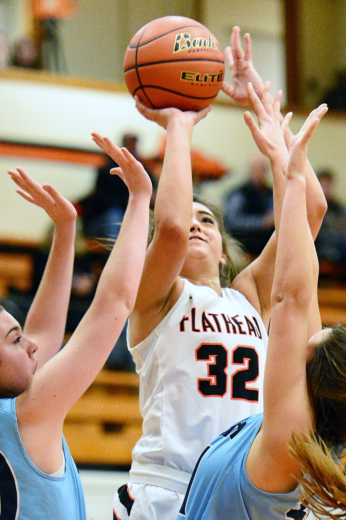 Flathead's Taylor Henley (32) shoots between a pair of Great Falls defenders at Flathead High School on Friday. (Casey Kreider/Daily Inter Lake)