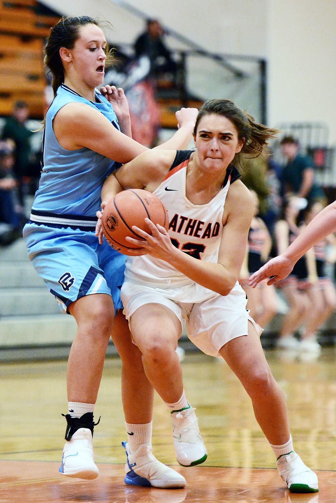 Flathead's Taylor Henley (32) drives to the hoop past Great Falls' Jorgie Hawthorne (31) in the first half against Great Falls at Flathead High School on Friday. (Casey Kreider/Daily Inter Lake)