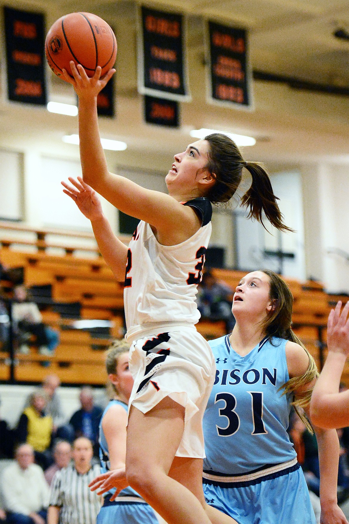 Flathead's Taylor Henley (32) drives to the hoop past Great Falls' Jorgie Hawthorne (31) in the first half at Flathead High School on Friday. (Casey Kreider/Daily Inter Lake)