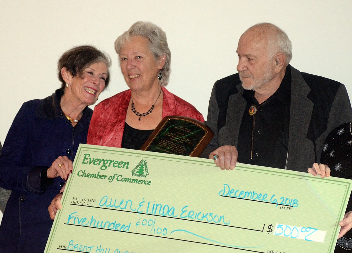 Linda and Allen Erickson are presented with the Brent Hall award by Barb Hall, left, at the Evergreen Chamber of Commerce banquet Thursday in Kalispell. (Matt Baldwin photos/Daily Inter Lake)