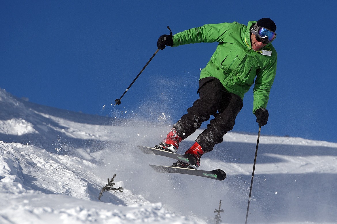 A skier catches some air heading down Russ's Street on opening day at Whitefish Mountain Resort on Thursday. (Casey Kreider/Daily Inter Lake)