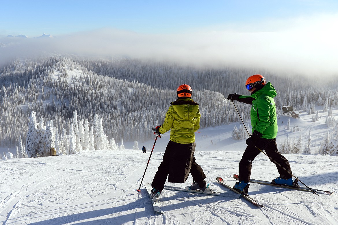 Skiers pause at the top of Russ's Street on opening day at Whitefish Mountain Resort on Thursday. (Casey Kreider/Daily Inter Lake)