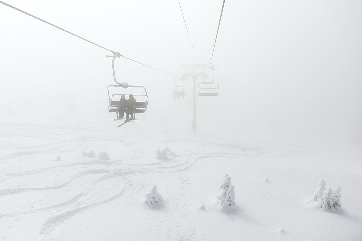 Skiers ride up to the summit on Chair 1 on opening day at Whitefish Mountain Resort on Thursday. (Casey Kreider/Daily Inter Lake)