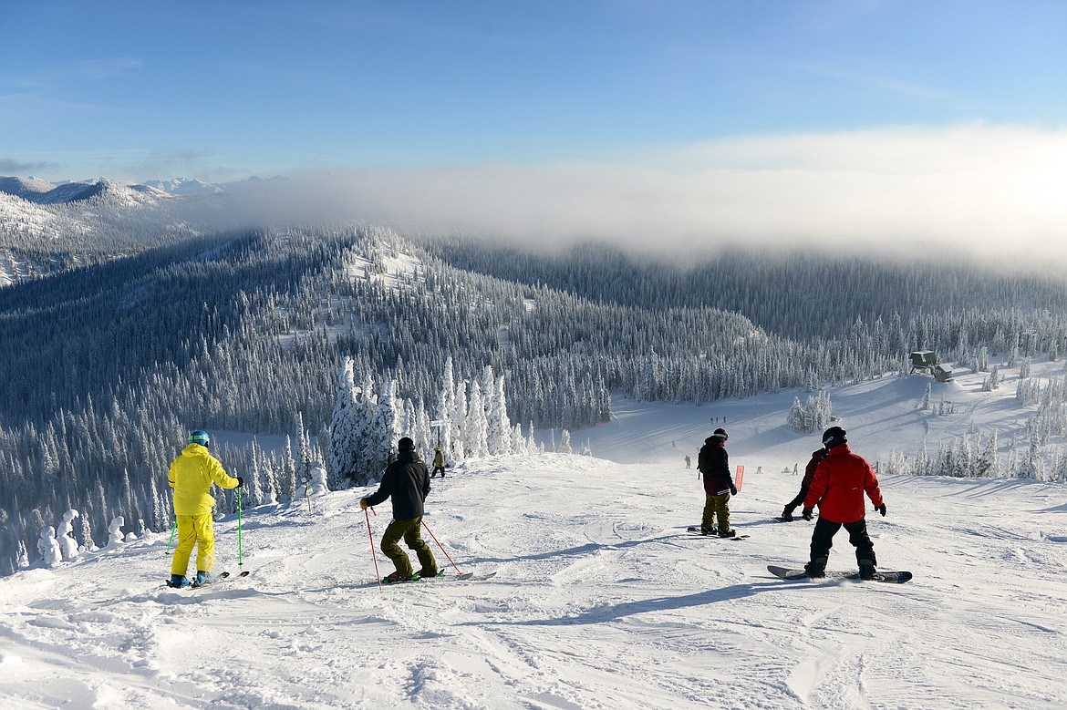 Skiers and snowboarders head down Russ's Street on opening day at Whitefish Mountain Resort on Thursday. (Casey Kreider/Daily Inter Lake)