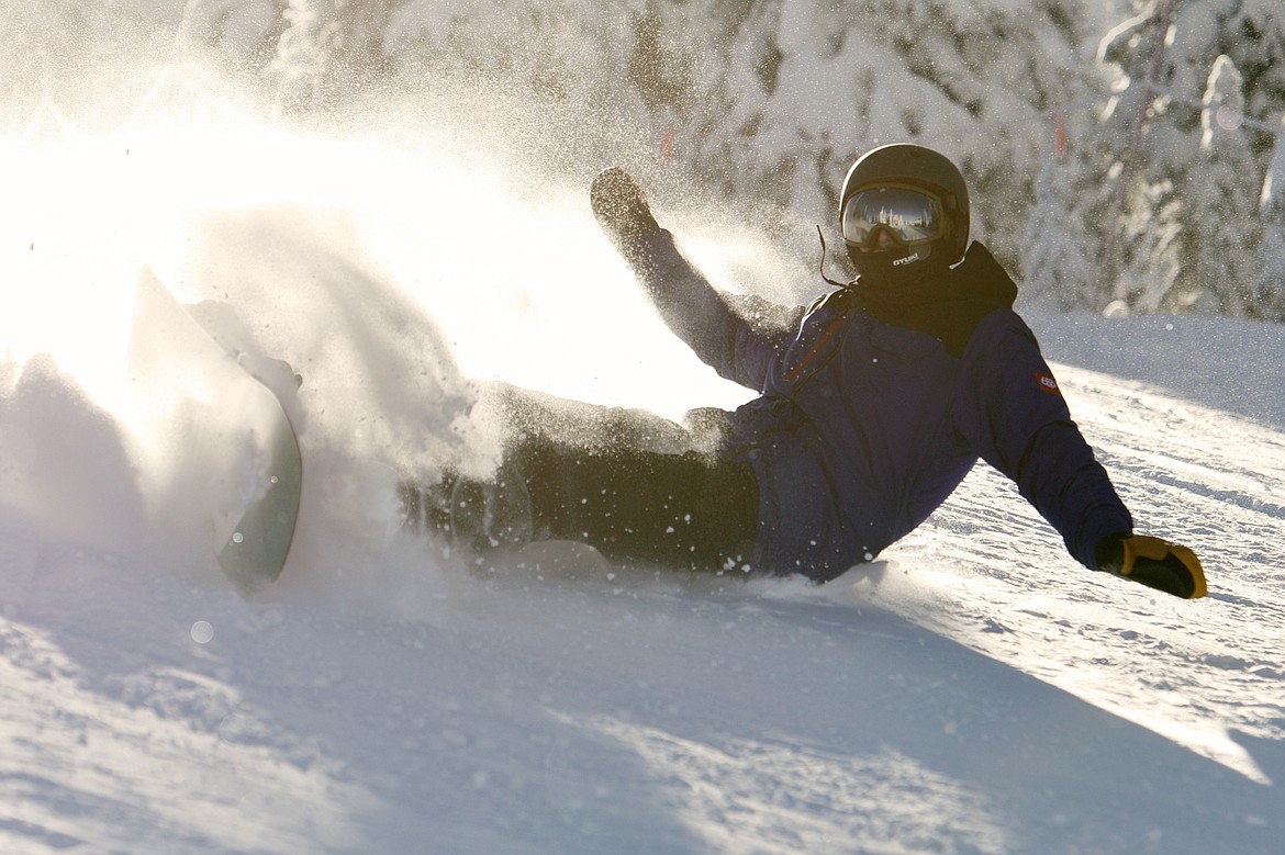 A snowboarder falls on opening day at Whitefish Mountain Resort on Thursday. (Casey Kreider/Daily Inter Lake)