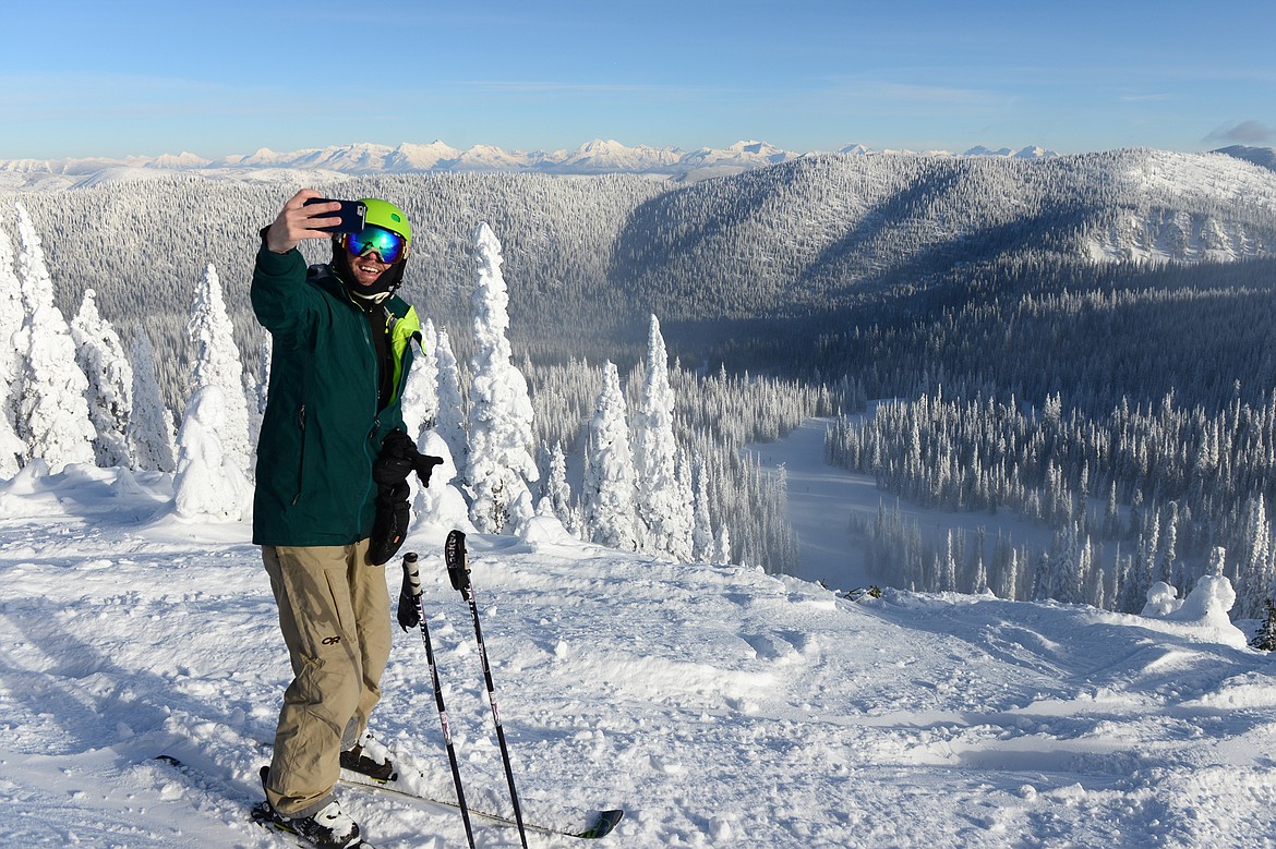 Robert Clase, of Kalispell, snaps a selfie along Russ's Street near Marmot on opening day at Whitefish Mountain Resort on Thursday. (Casey Kreider/Daily Inter Lake)