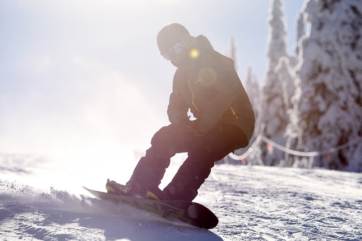 A snowboarder rides down a trail on opening day at Whitefish Mountain Resort on Thursday. (Casey Kreider/Daily Inter Lake)