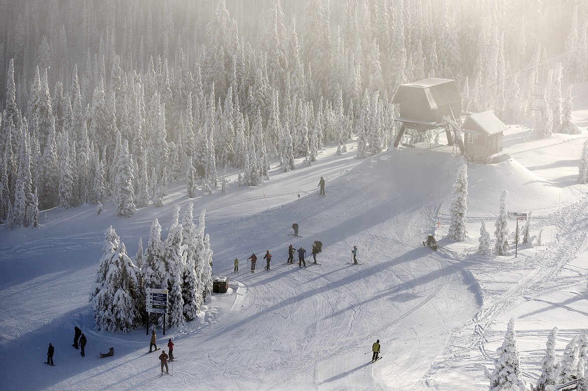 Skiers and snowboarders congregate at a junction on Russ's Street on opening day at Whitefish Mountain Resort on Thursday. (Casey Kreider/Daily Inter Lake)