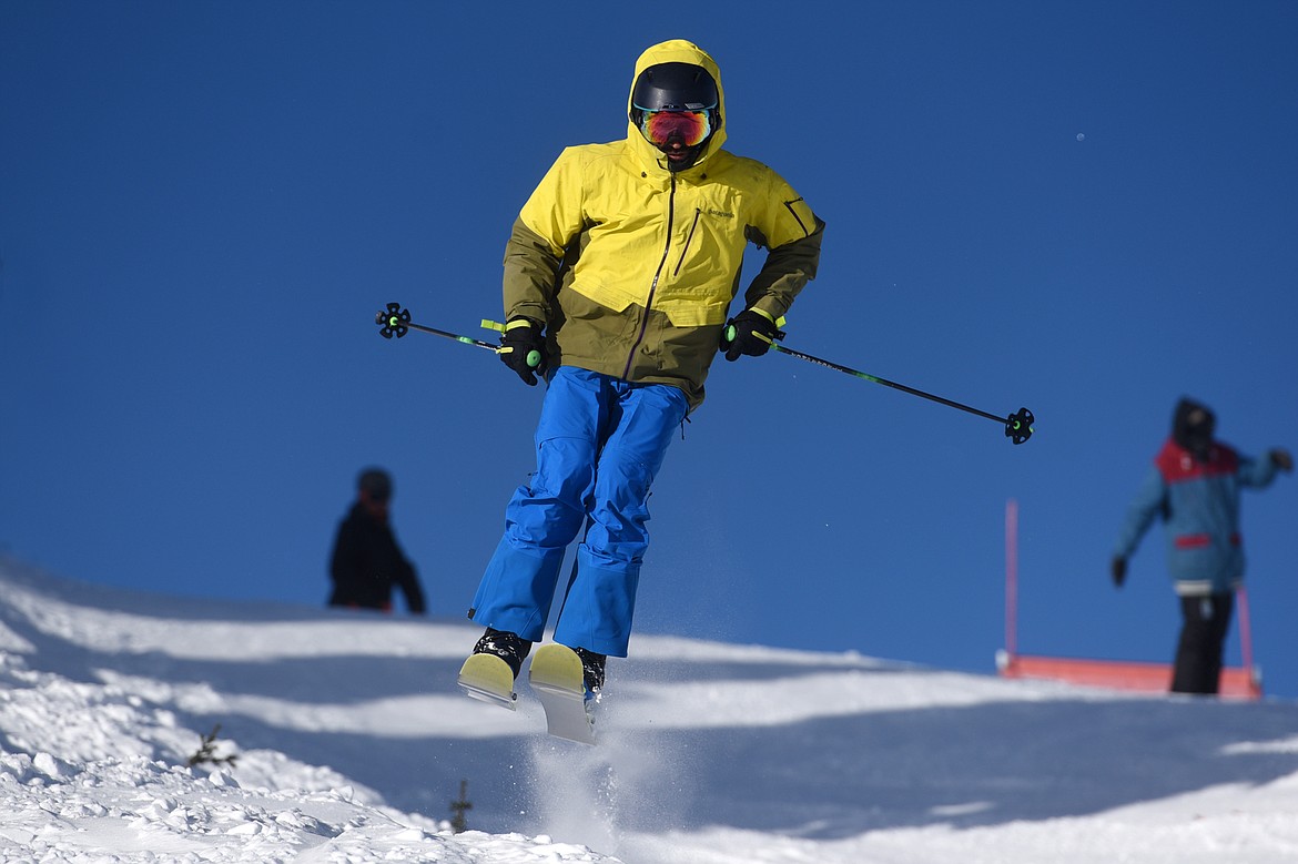 A skier catches some air heading down Russ's Street on opening day at Whitefish Mountain Resort on Thursday. (Casey Kreider/Daily Inter Lake)