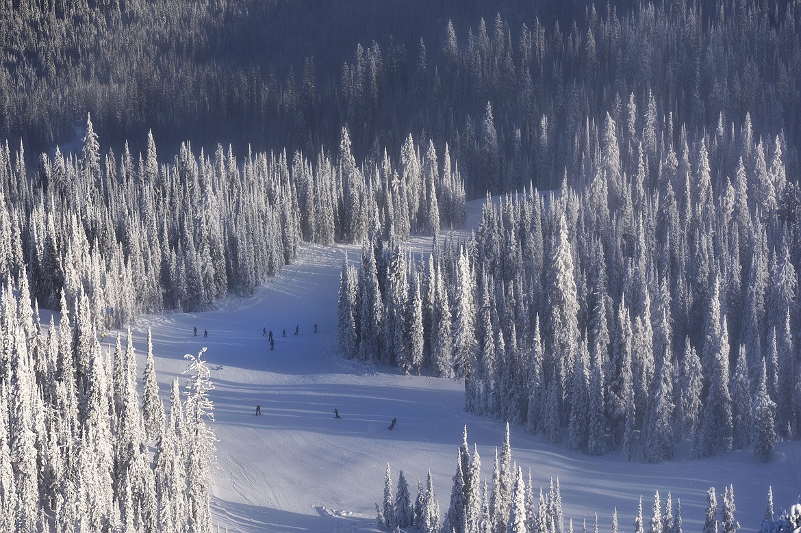 Skiers and snowboarders weave down the mountain on opening day at Whitefish Mountain Resort on Thursday. (Casey Kreider/Daily Inter Lake)