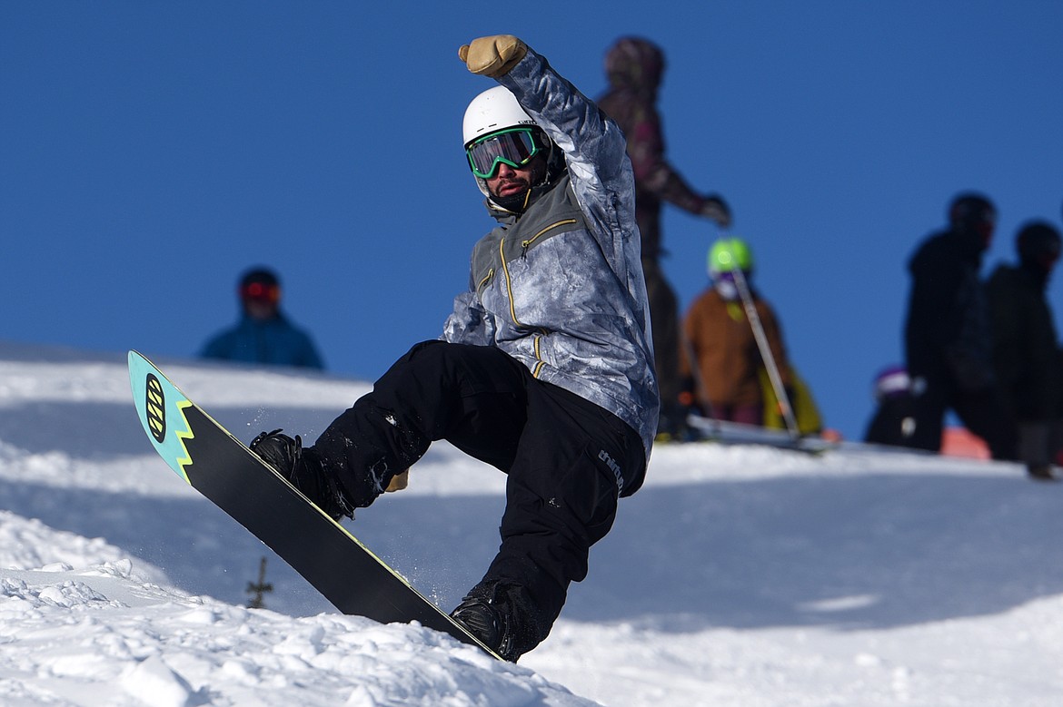 A snowboarder heads down Russ's Street on opening day at Whitefish Mountain Resort on Thursday. (Casey Kreider/Daily Inter Lake)