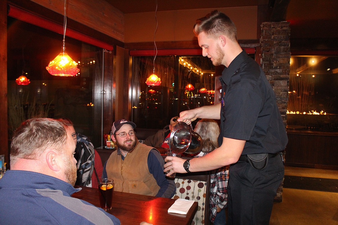 Cheryl Schweizer/Columbia Basin Herald
Moses Lake Police officers served food and topped off water glasses during Tip a Cop Wednesday night. Proceeds go to the Shop With a Cop program.