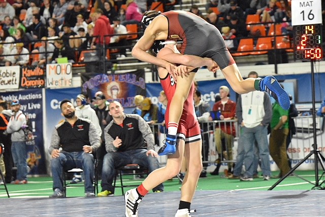 (Photo by ERIC PLUMMER) Sandpoint senior Casey Olesen, hoists his opponent during the Idaho 4A wrestling championships last year.