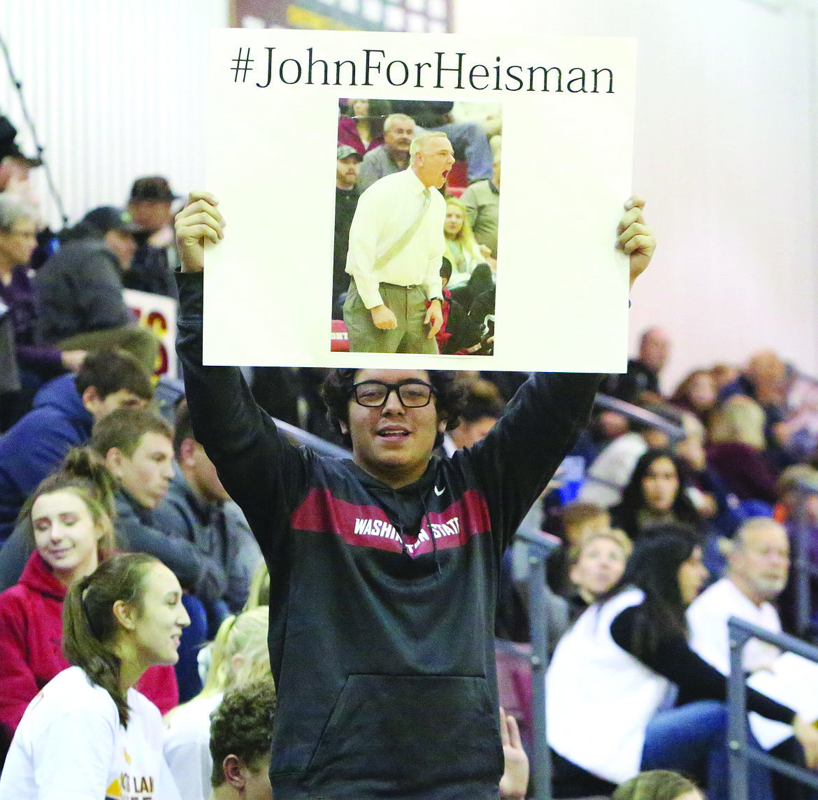 Connor Vanderweyst/Columbia Basin Herald
Moses Lake High School senior Edgar Ortiz holds up a sign depicting head boys basketball coach John Hohman.