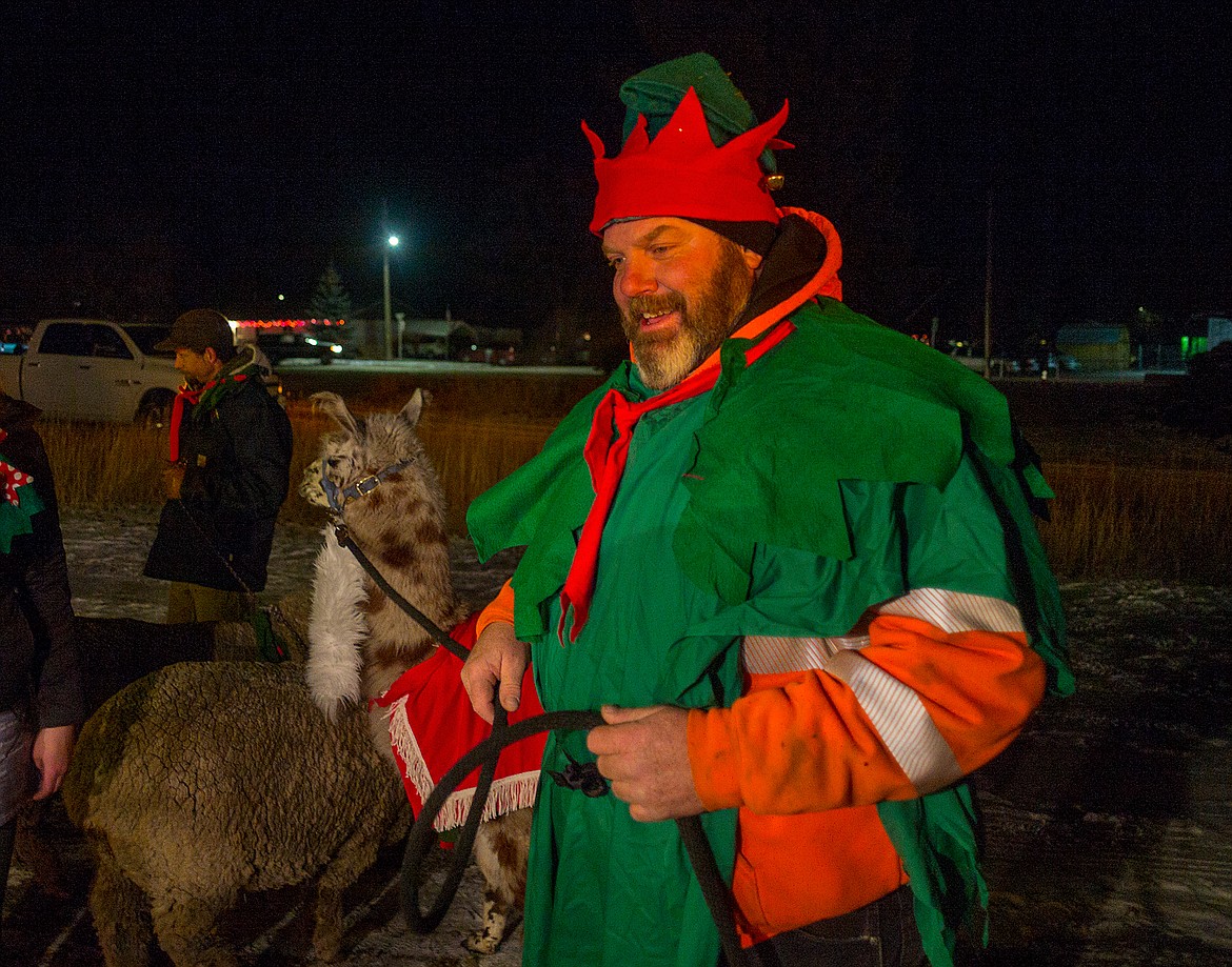 Doug Yeager, the 6-4 elf and his llama, Paul.