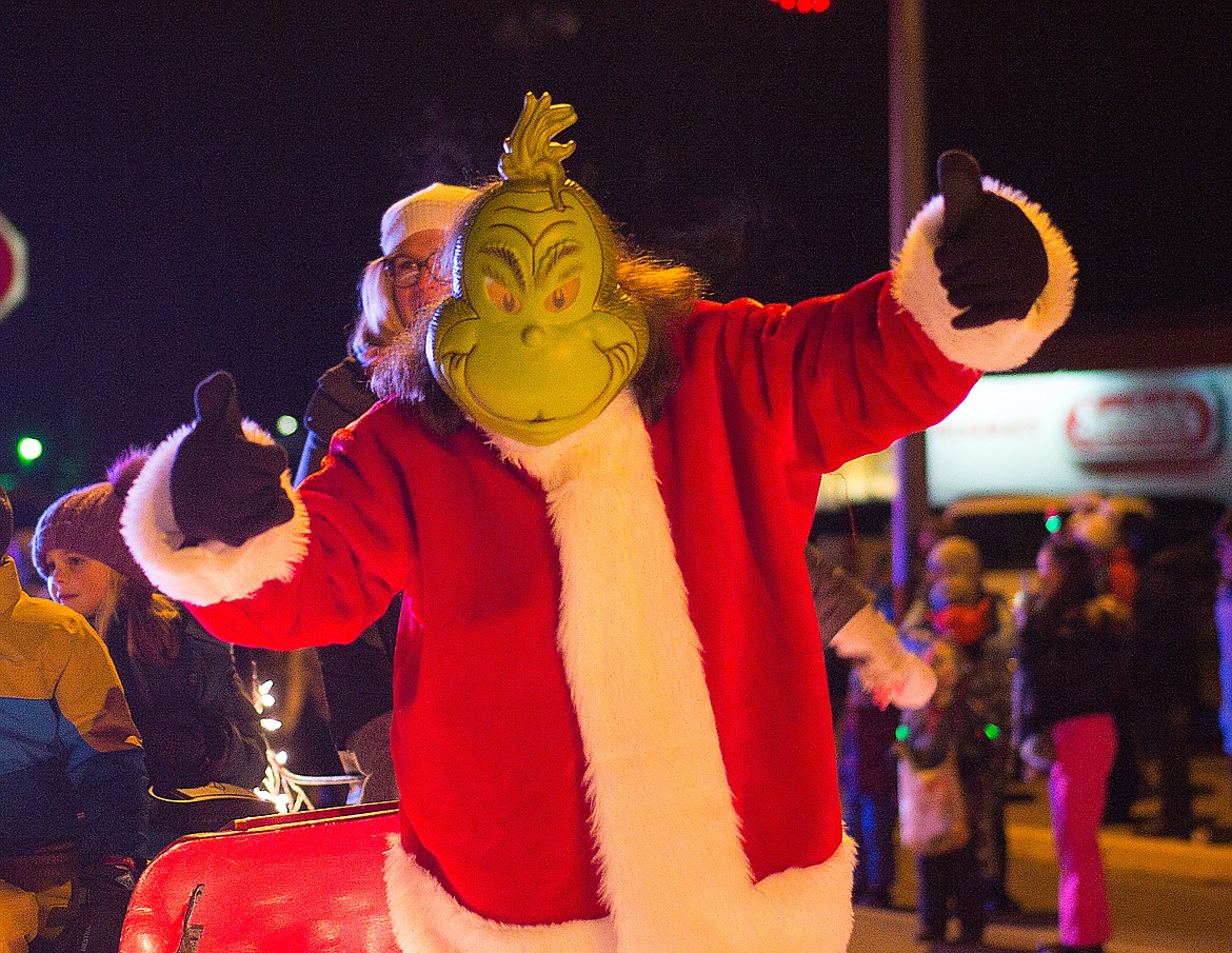 The Grinch waves to the crowd.