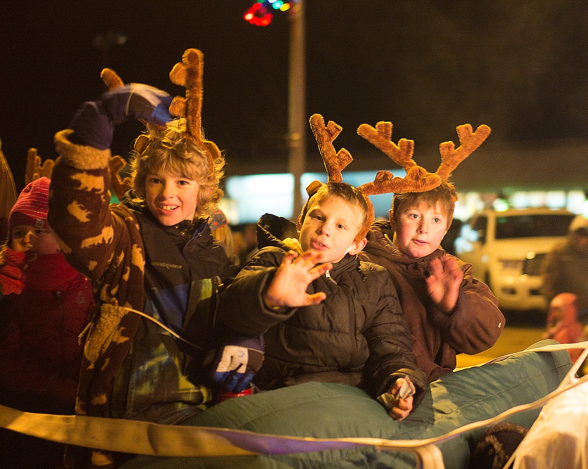 Boys wave from the Flathead National Forest float.