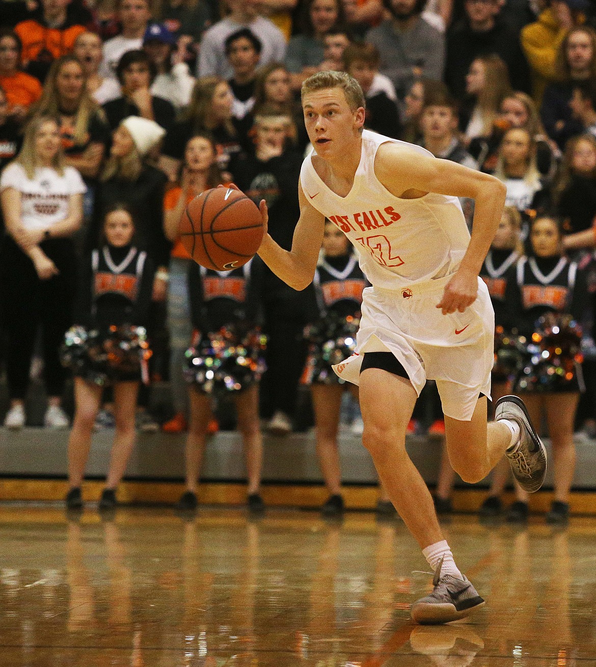 Post Falls guard Isaac Ballew dribbles the ball down the court against Rogers Friday night at Post Falls High School. (LOREN BENOIT/Press)