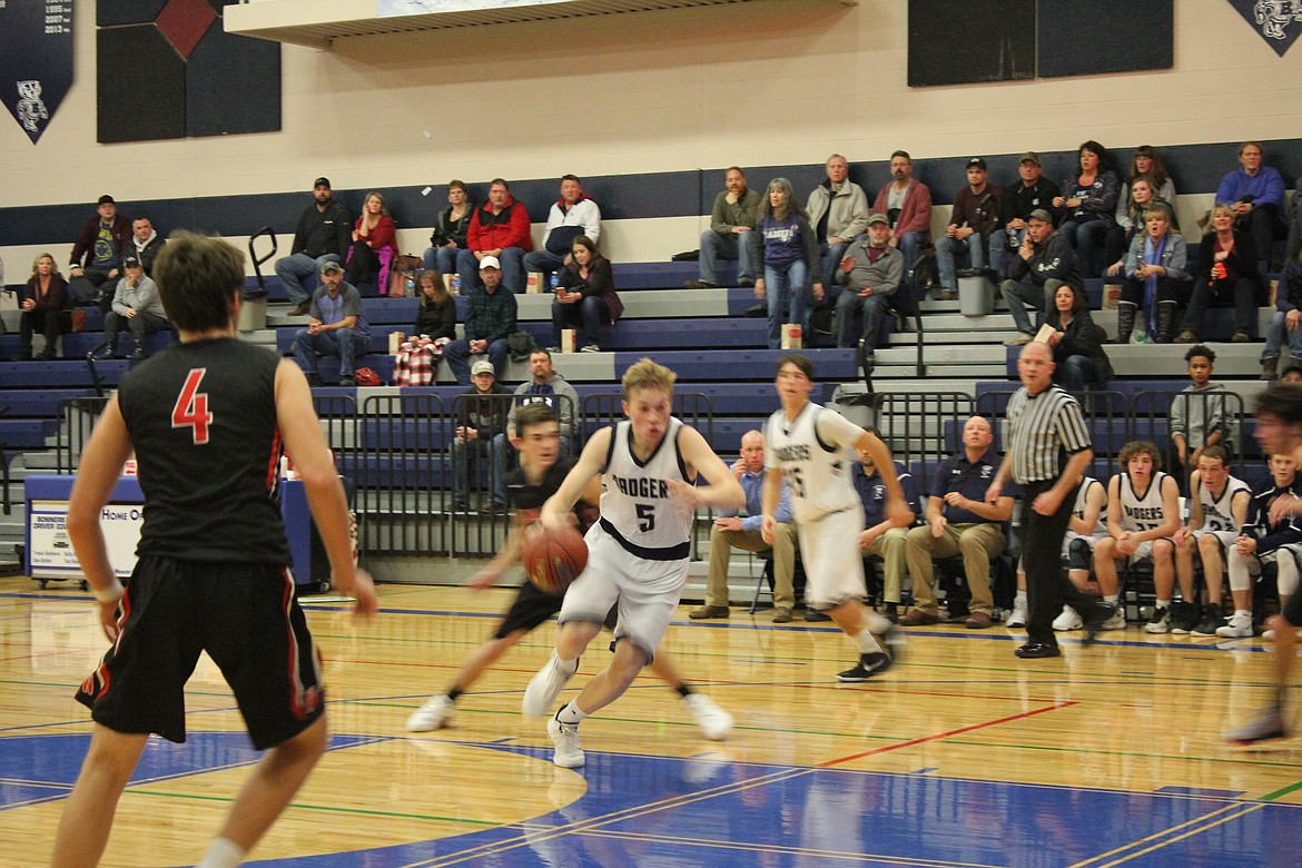 Photos by TANNA YEOUMANS
Above: Bonners Ferry&#146;s Seth Bateman drives through the Wallace defense.
Right: Caleb Peterson shoots the ball over a Cusick defender.