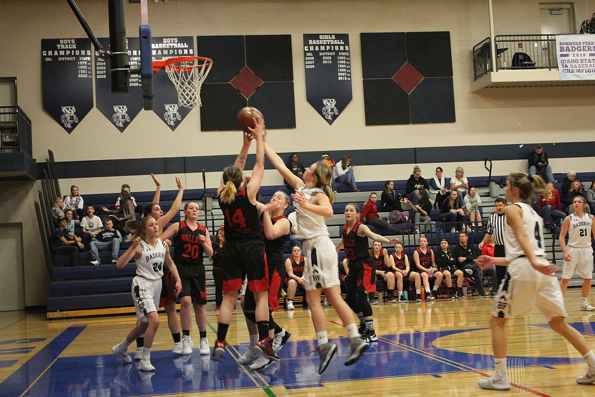 Photo by TANNA YEOUMANS
Wallace and Bonners Ferry players fight for a rebound during the Badgers&#146; 61-27 home win.