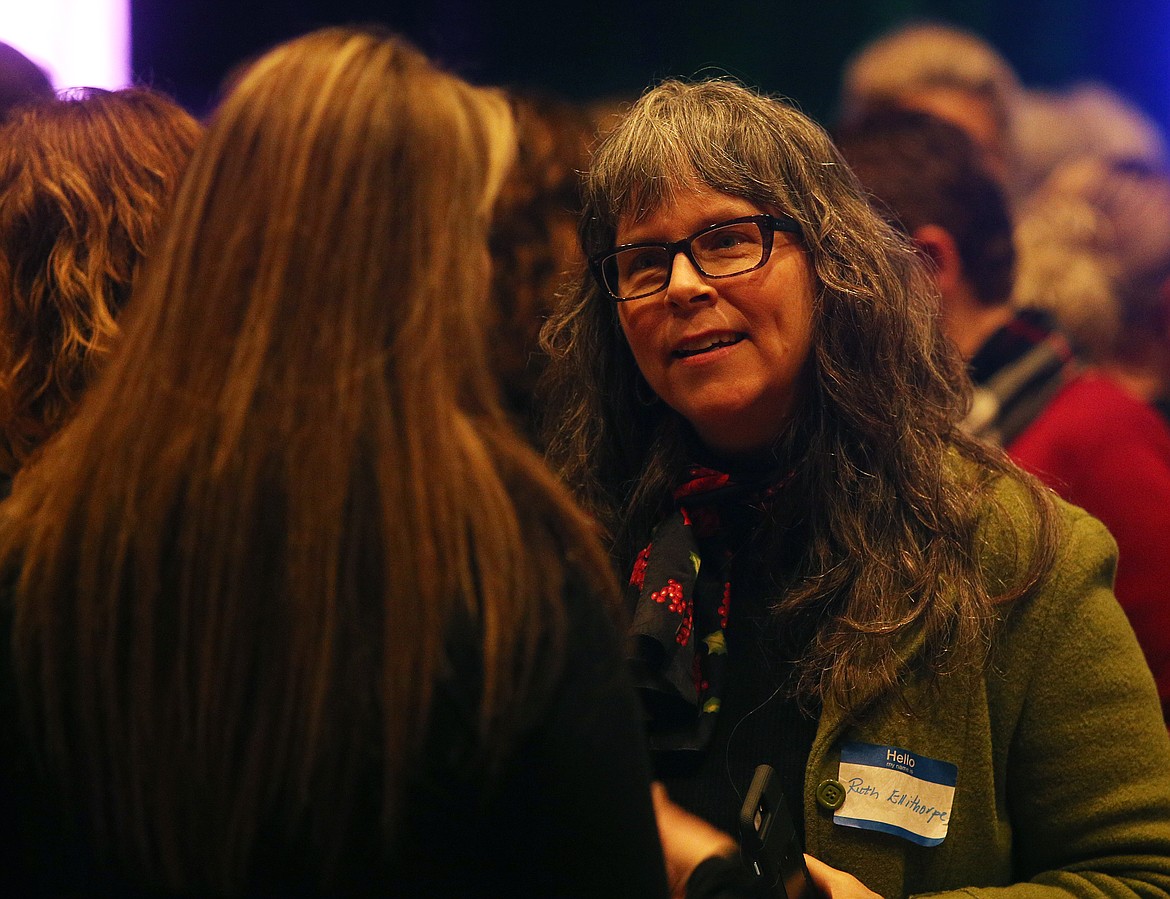 Ruth Ellithorpe networks with Scarlet Kelso during Friday evening's Women's Entrepreneurship Day conference in Schuler Auditorium at North Idaho College.(LOREN BENOIT/Press)