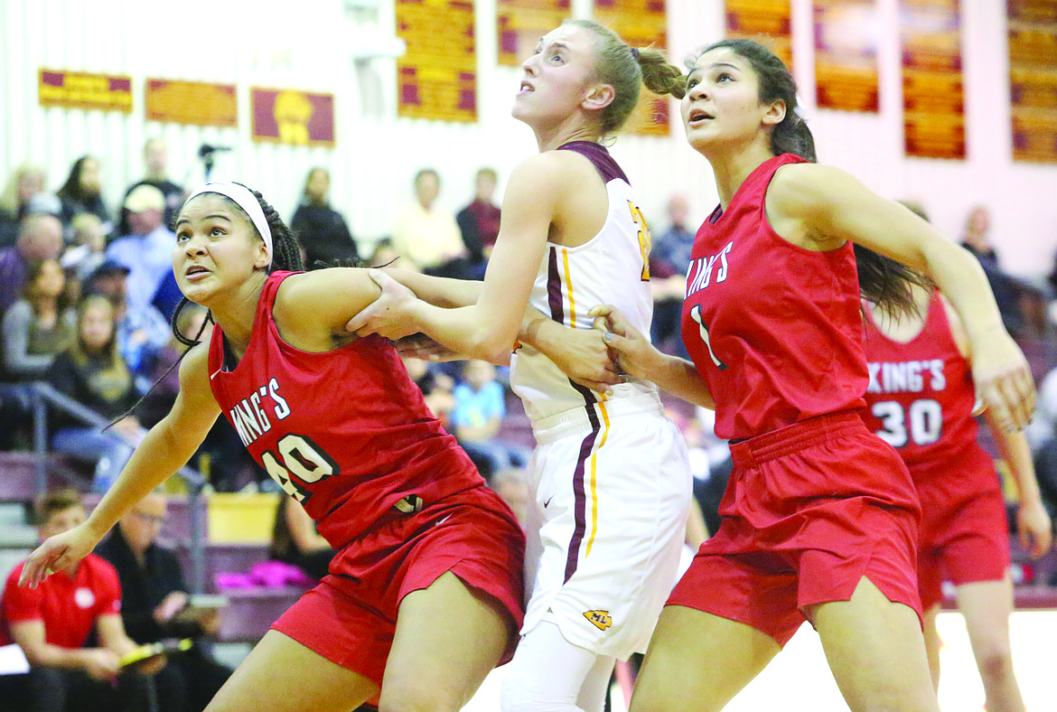 Connor Vanderweyst/Columbia Basin Herald
Moses Lake's Camille Carpenter (center) fights for rebounding position between King's players Jadyn Kirton (40) and Dominique Kirton (1).