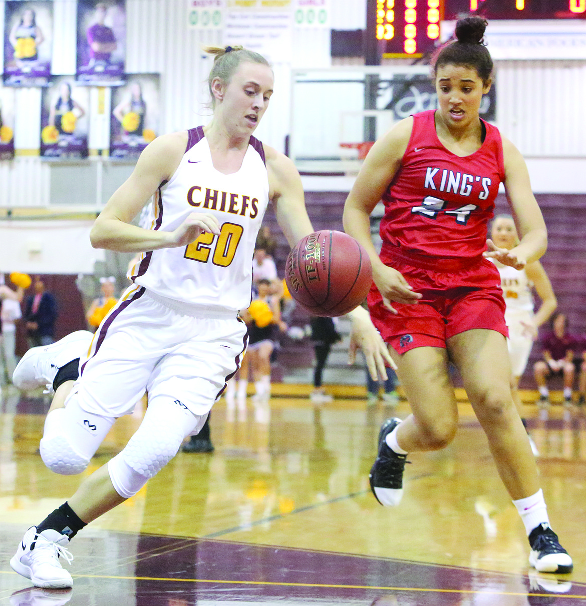 Connor Vanderweyst/Columbia Basin Herald
Moses Lake's Camille Carpenter tracks down the opening tip in front of King's guard Jada Wynn.