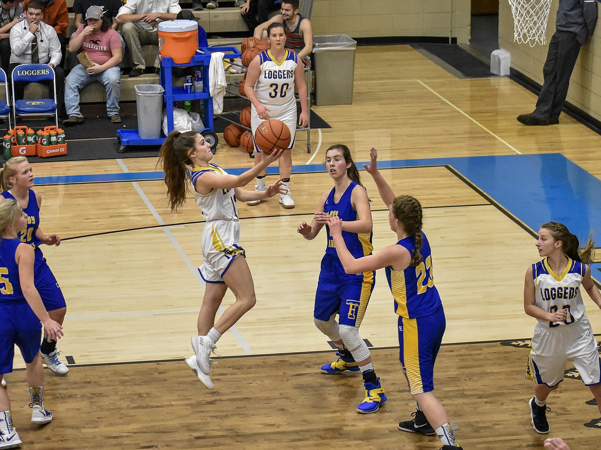 Libby senior Alli Collins aims over the heads of the Thompson Falls defense as she goes up for two in the first quarter of the Lady Loggers&#146; 51-31 win over the Lady Hawks Saturday. (Ben Kibbey/The Western News)