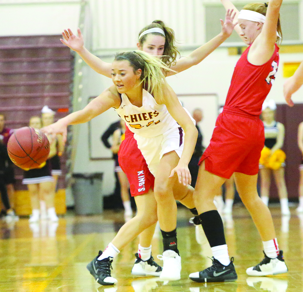 Connor Vanderweyst/Columbia Basin Herald
Moses Lake guard Madisyn Clark finds room between two King's defenders to keep her dribble alive.