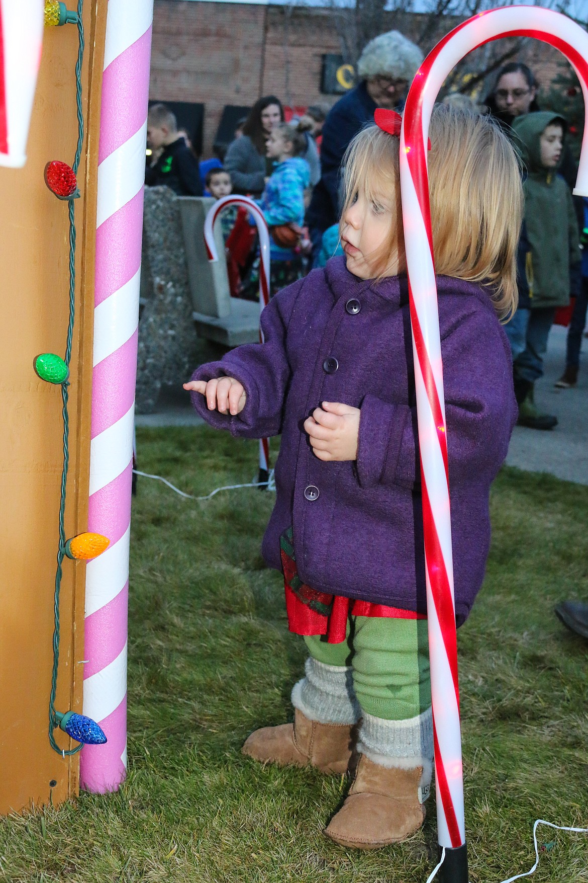 Photo by MANDI BATEMAN
17-month old Lenora Olson inspects the decorations while awaiting her turn with Santa Claus.