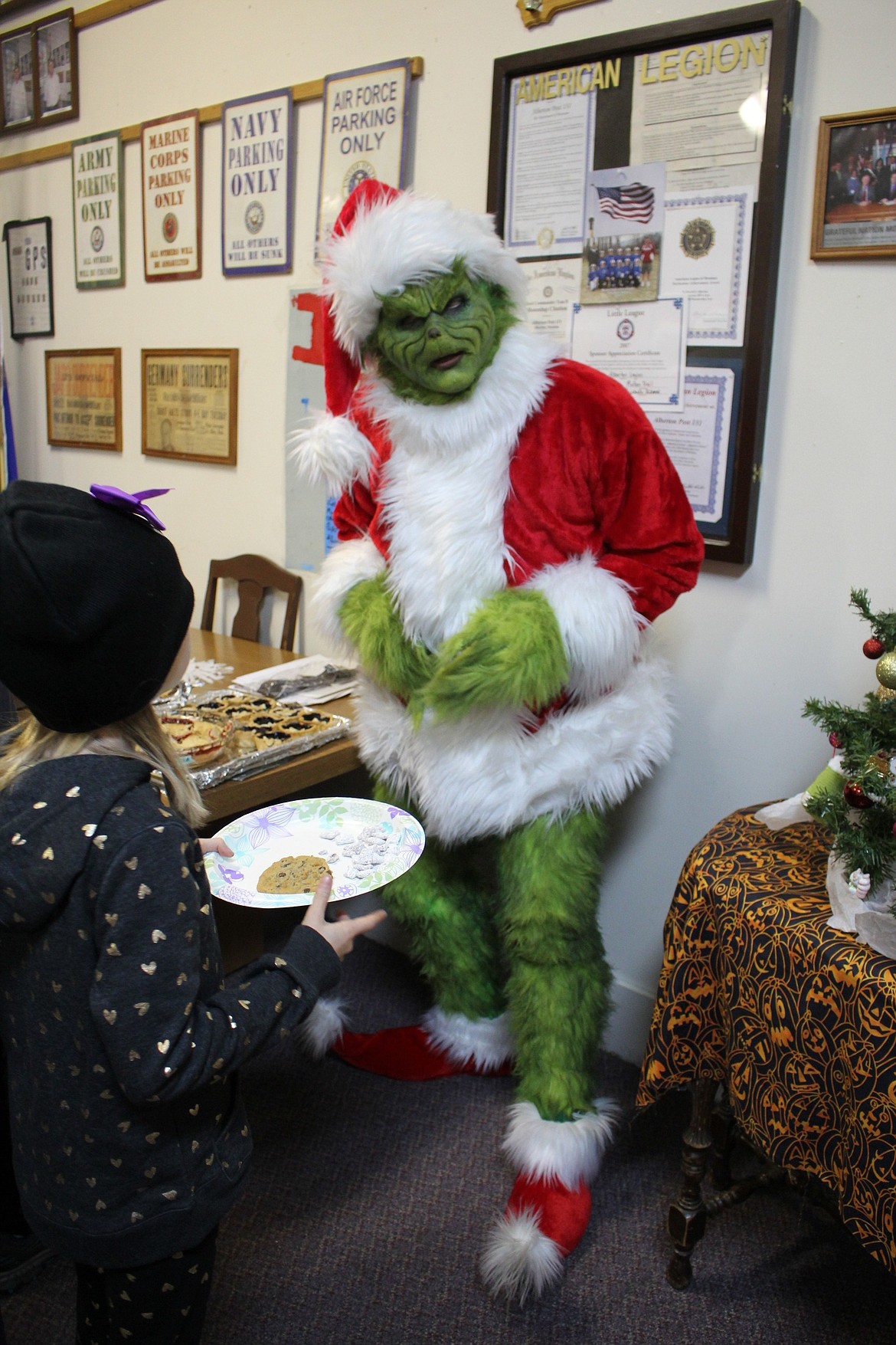 The Grinch (aka Matt Sibert of Alberton) entertains kids at the PEAK Foundation&#146;s annual tree lighting ceremony and community potluck dinner held on Nov. 2 in Alberton. (Kathleen Woodford/Mineral Independent)