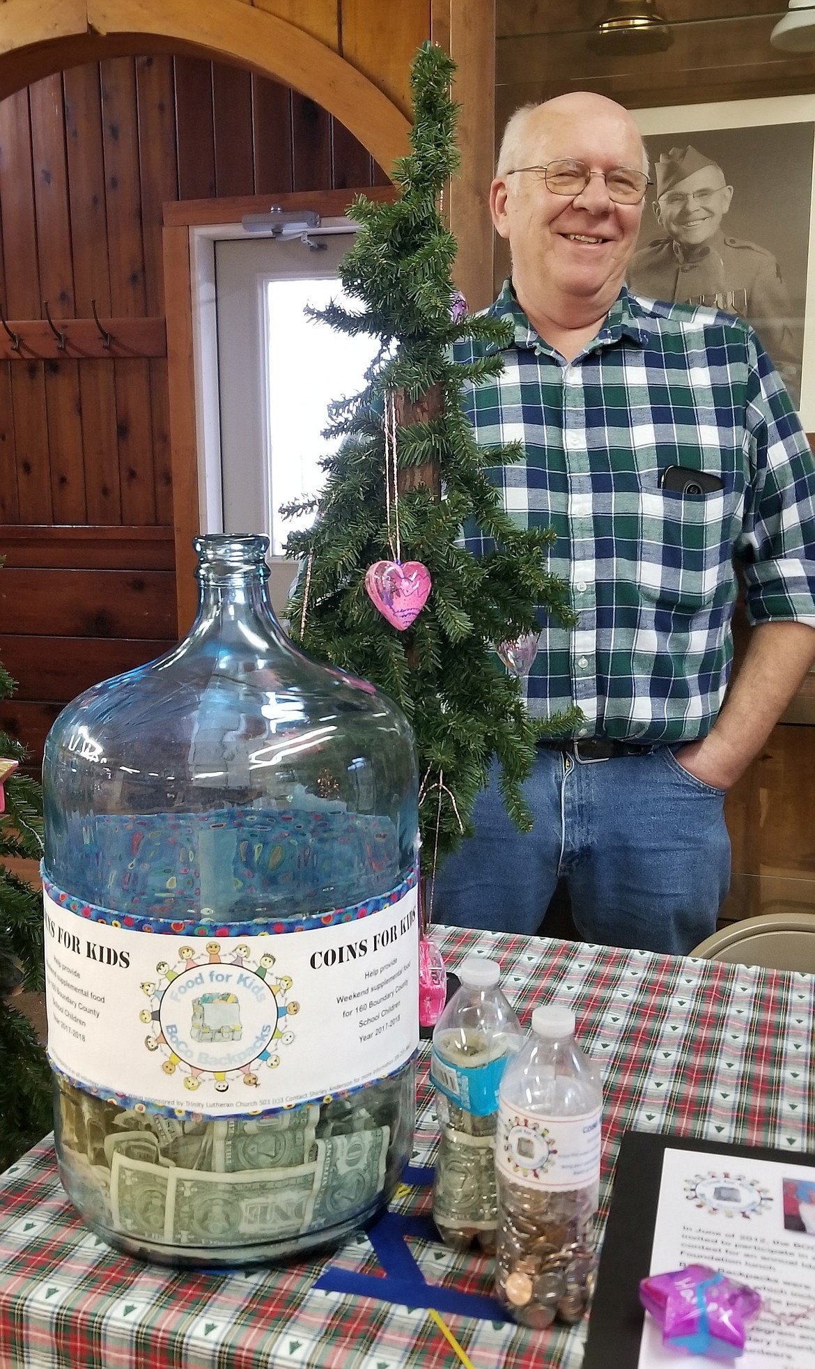 Photo by MANDI BATEMAN
Merle Dinning with the BoCo Backpack table and ornaments made by local fifth graders.