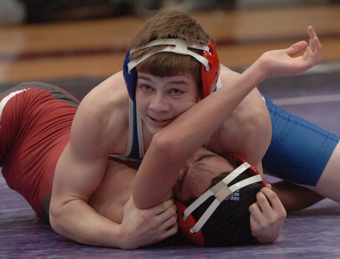 At 132 pounds, Wesley Buchannen placed sixth. Above, Buchannen wrestles against Joe Doane from Hamilton in an early-round match, winning the match by fall.