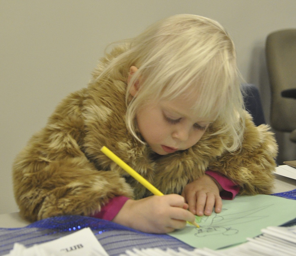 Luna Billington, 4, colors a Tinker Bell sheet at the opening of the Ronan Boys &amp; Girls clubhouse. Luna and her grandparents showed their support of the club&#146;s milestone Tuesday, Nov. 27. (Ashley Fox/Lake County Leader)